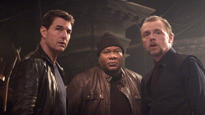 Ethan Hunt, Luther, and Benji stand in a dark room in "Mission: Impossible -- Dead Reckoning" (2023)