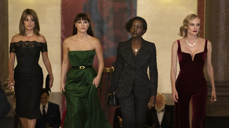 Mace, Khadijah, Marie, and Graciela walking side-by-side in elegant formal wear in "The 355" (2022)