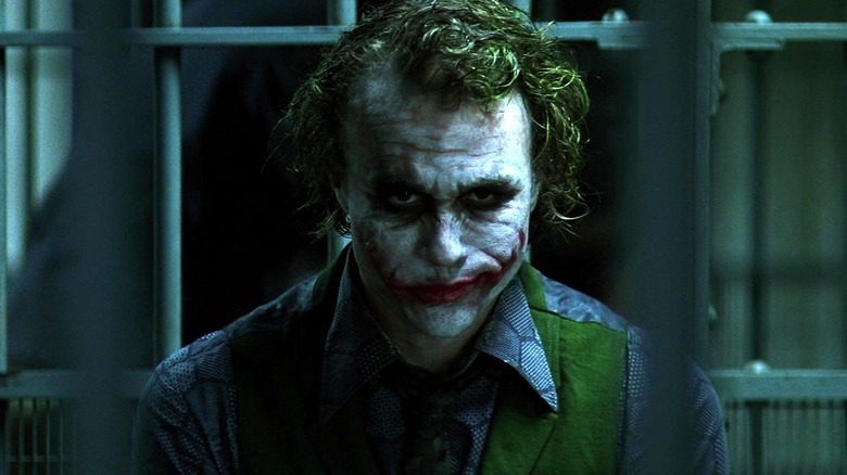 The Joker smiling in jail in The Dark Knight (2008)