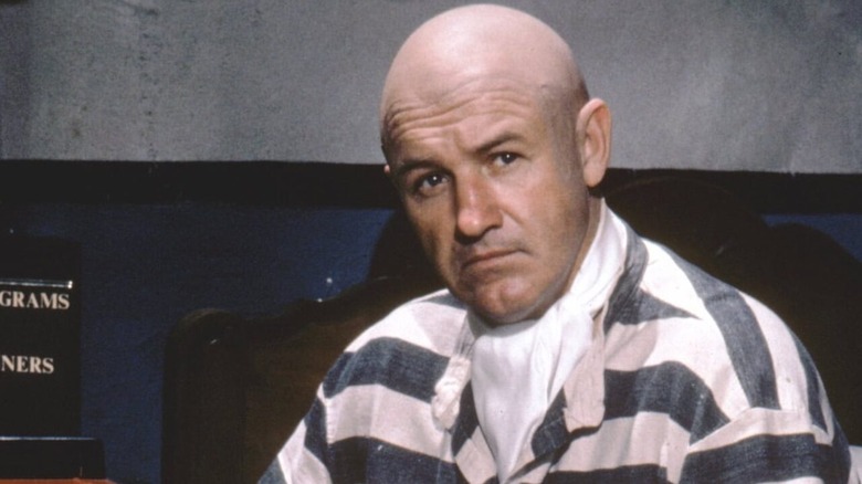 Lex Luthor, with his head shaved, wears a black and white prison jumpsuit in "Superman"