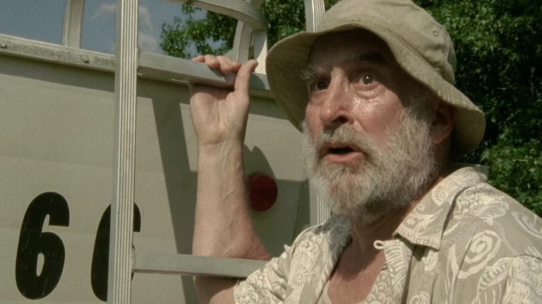 Dale holding onto a trailer on "The Walking Dead"