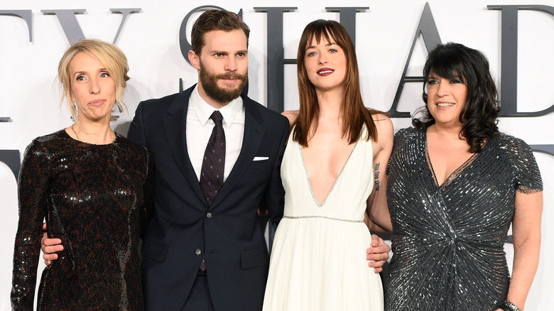 Sam Taylor-Johnson, Jamie Dornan, Dakota Johnson, and author E.L. James smiling at the UK Premiere of "Fifty Shades Of Grey" (2015)