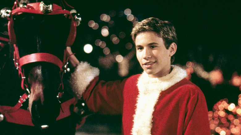 Jake smiles next to a horse in "I'll Be Home For Christmas" (1998)