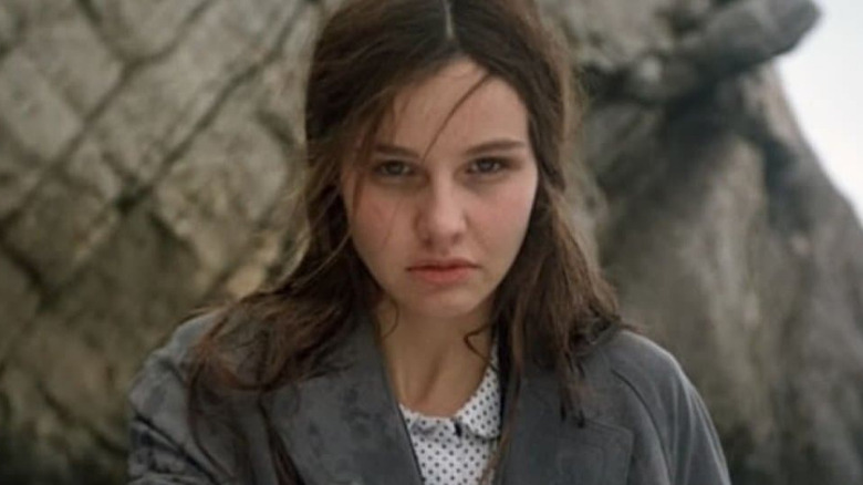 Vera Claythorne standing by cliffs in "Ten Little Indians."