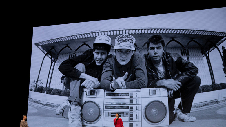 The Beastie Boys speaking in front of old image of themselves in "Beastie Boys Story"