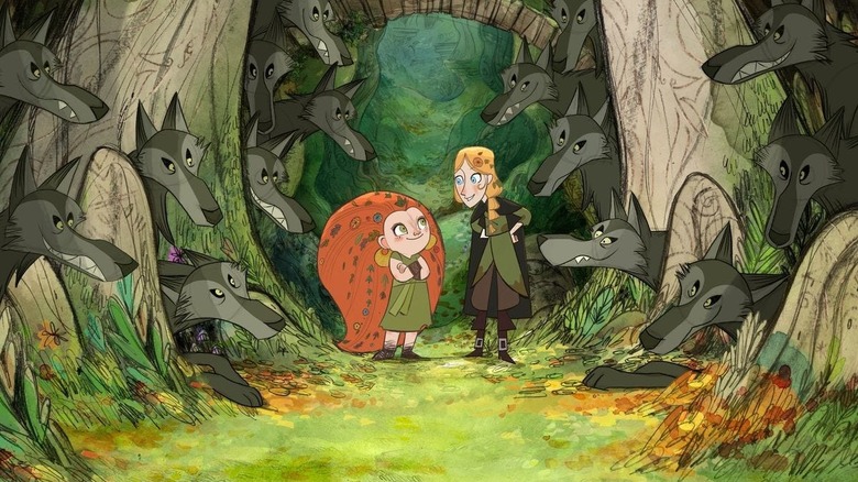 Mebh and Robyn chatting alongside a wolf pack in "Wolfwalkers"