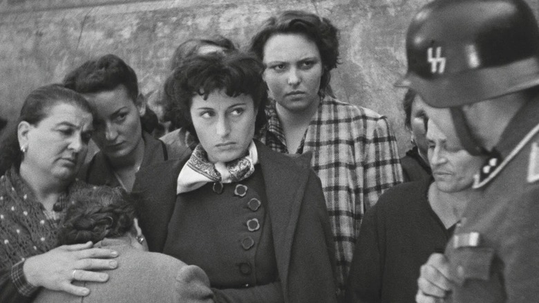 An SS officer harassing Roman citizens in Rome, Open City (1945)