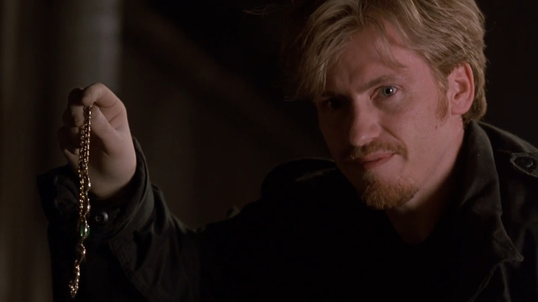 Gus waving around a piece of pilfered jewelry in "The Ref" (1994)