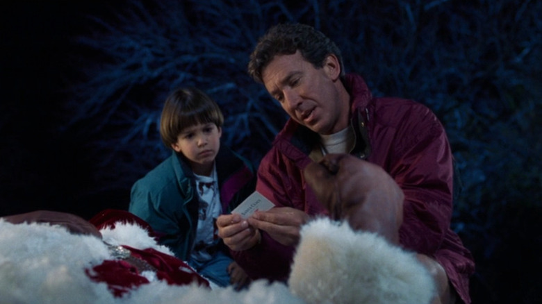 Scott checking out Santa's card with Charlie in "The Santa Clause" (1994)