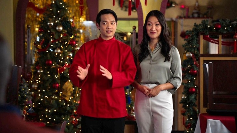 Rick and Romy stand together inside the Golden Dragon in Christmas at the Golden Dragon (2022)