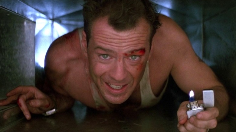 John McClane crawls through an air vent with lighter in Die Hard (1988)