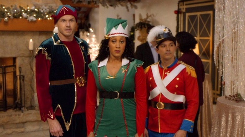 Ryan Anderson, Tanya Morris, and Talbot stand together in costumes in The Santa Stakeout (2021)