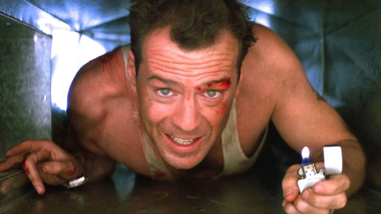 John McClane using his lighter in an air vent in Die Hard