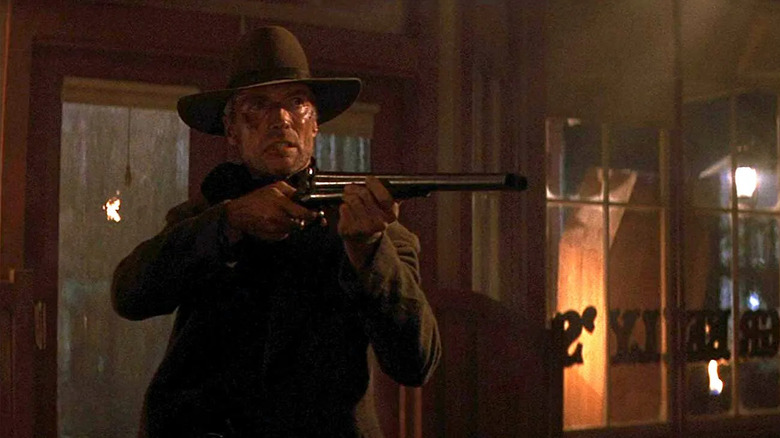 Will Munny aims a rifle in "Unforgiven" (1992)