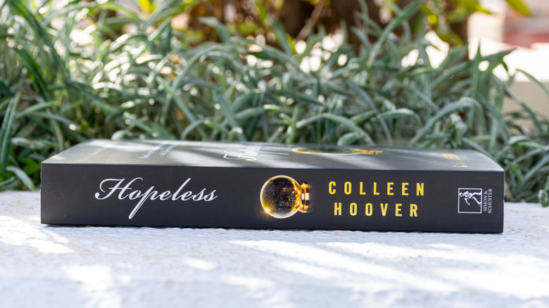Side view of Colleen Hoover's Hopeless book outside