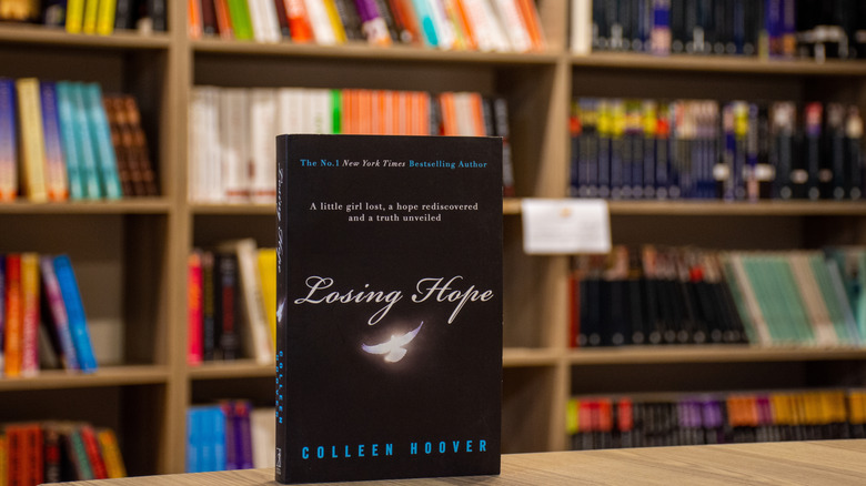 Close-up of Colleen Hoover's Losing Hope novel in the bookstore