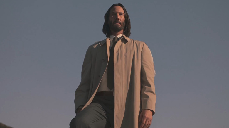 Gabriel standing on top of a building, looking out over Los Angeles (off screen)