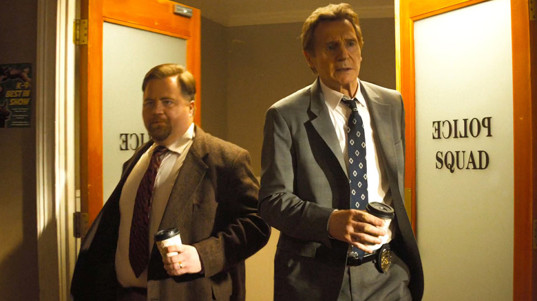 Capt. Ed Hocken Jr. and Lt. Frank Drebin Jr. walking through double, swinging doors labeled "Police Squad"