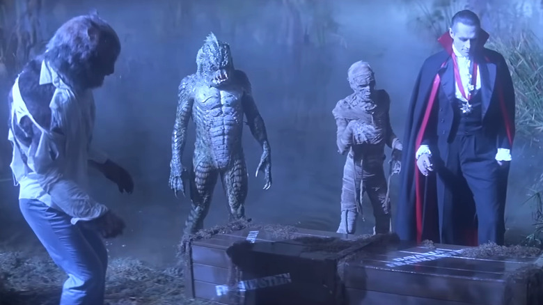 Jonathan Gries's Wolf Man, Tom Woodruff Jr.'s Gill-man, Michael Reid MacKay's Mummy, and Duncan Regehr's Dracula standing over a crate in The Monster Squad