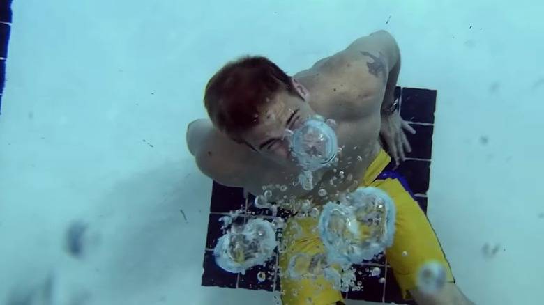 Hunt sitting on a pool drain underwater, bubbles escaping from his mouth, in "The Final Destination" (2009)