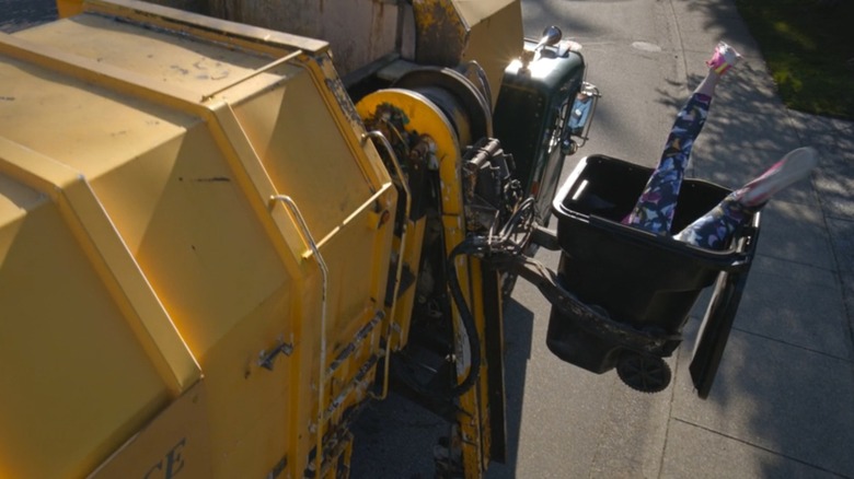 Julia is lifted into a garbage truck, legs sticking out of a garbage can, in "Final Destination Bloodlines" (2025)
