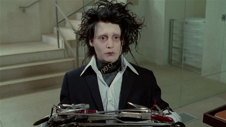 Edward standing seriously in 