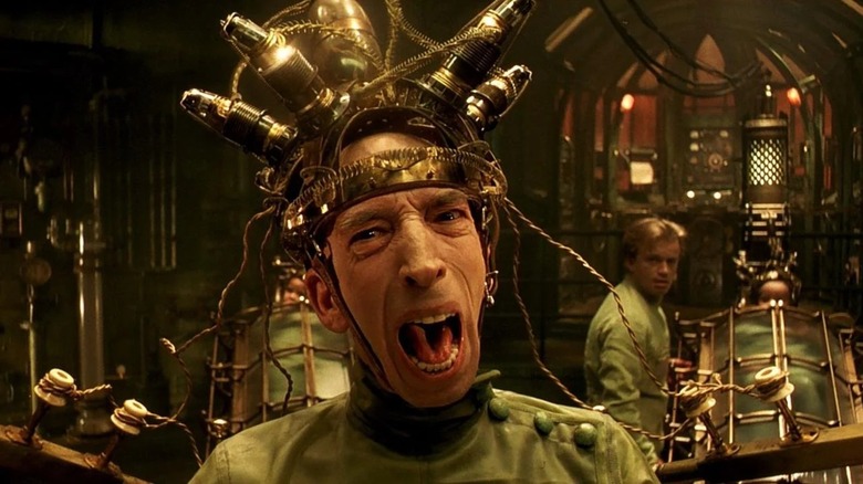 Krank screaming with equipment on his head in "The City of Lost Children"