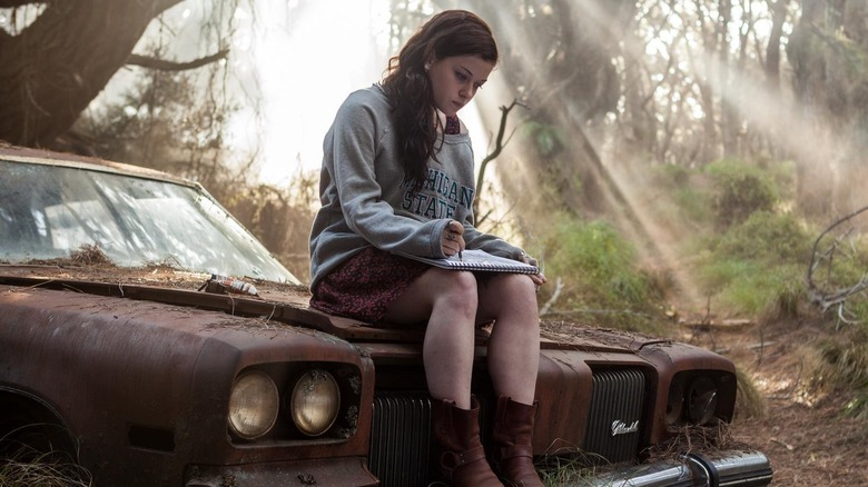 Mia sketches on a dead Oldsmobile in "Evil Dead" (2013)