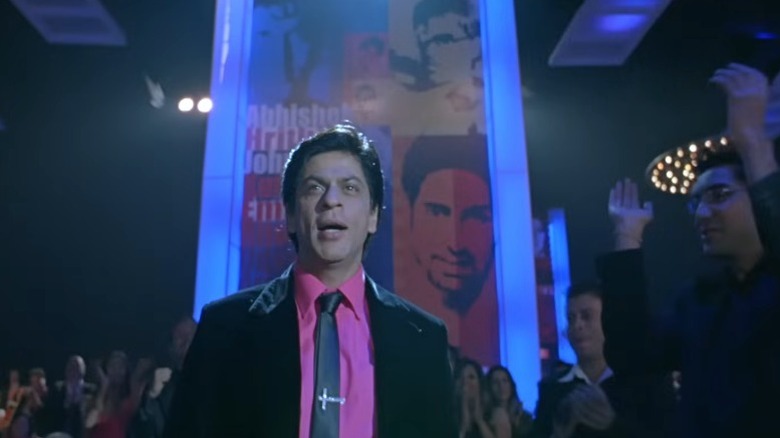 Om standing under blue lights in a gala event in Om Shanti Om