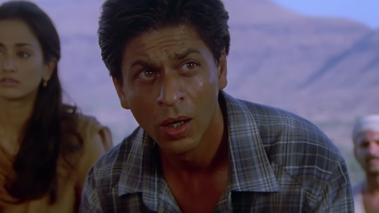Mohan furrowing his brows while looking to his left in Swades
