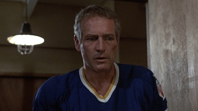 Reggie Dunlop in Chiefs jersey scowling in kitchen