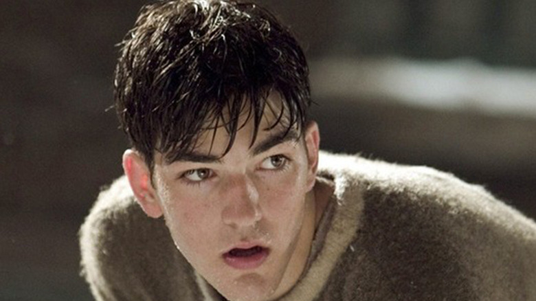 Maurice Richard with sweaty hair in brown hockey jersey