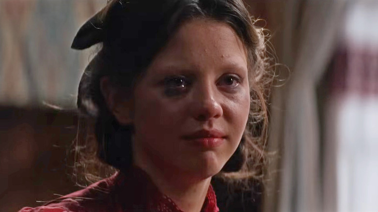 Pearl crying at the dinner table in "Pearl" (2022)