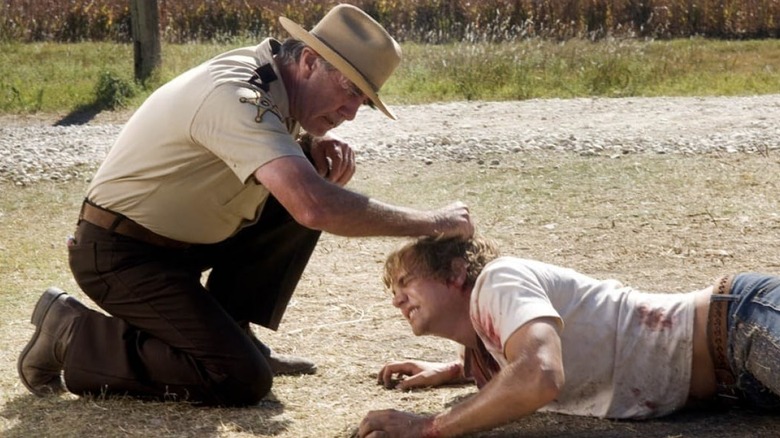 Sheriff Hoyt/Charlie Hewitt terrorizes Dean in "The Texas Chainsaw Massacre: The Beginning" (2006)