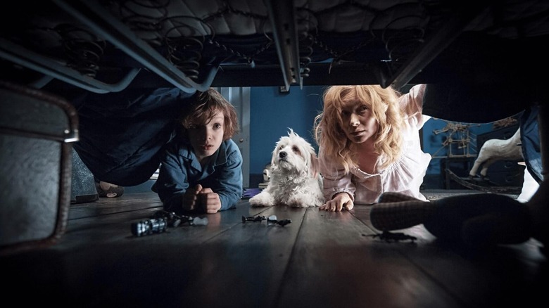 Amelia and Samuel look under the bed in The Babadook (2014)