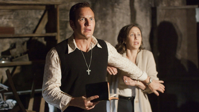 Ed Warren guards Lorraine Warren in The Conjuring (2013)