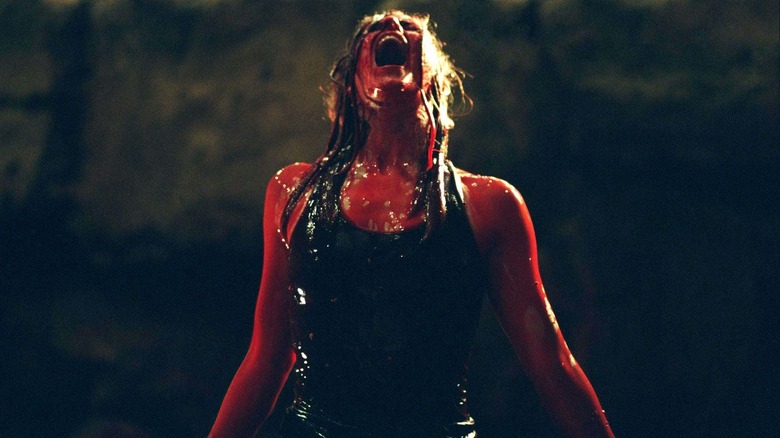 Sarah emerges from bloody water in The Descent (2005)