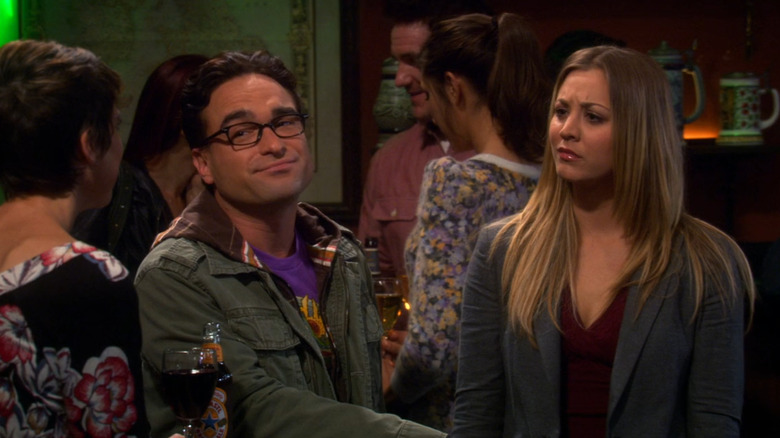 Leonard and Penny looking at a woman just off camera in The Big Bang Theory (2007)