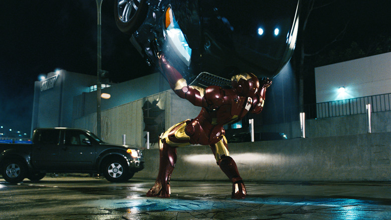 Iron Man catching a car in a fight scene in "Iron Man" (2008)