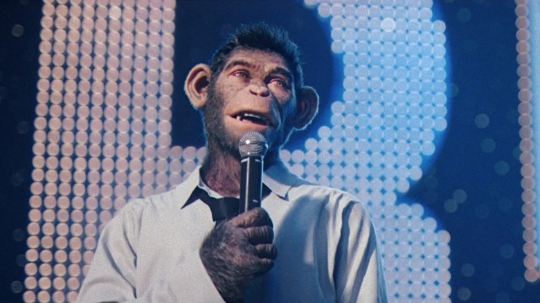 Robbie Williams in monkey form performing for a crowd in "Better Man" (2024)