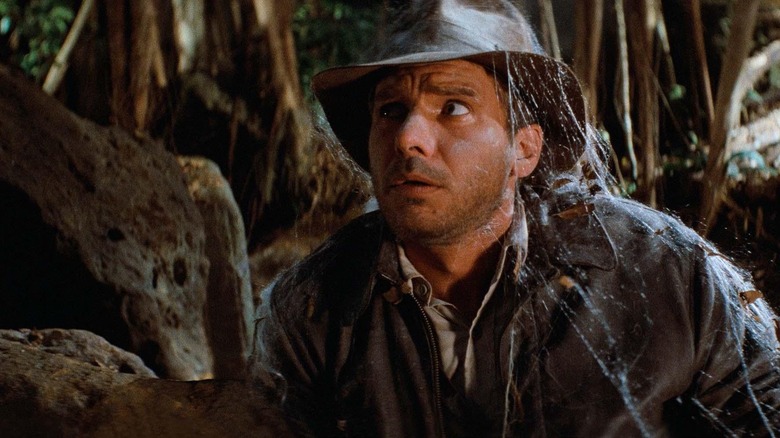 Indy covered in spider webs in Raiders of the Lost Ark (1981)