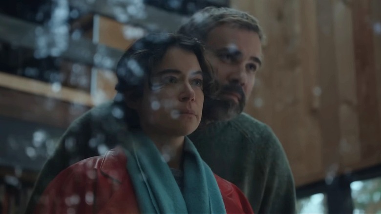 Liz and Malcolm looking out the window in Keeper