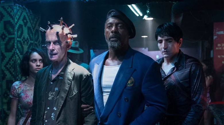 Bloodsport stands with the Thinker, flanked by Ratcatcher and Polka-Dot Man in The Suicide Squad
