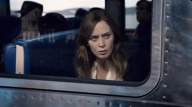 Rachel looking suspiciously out of the train window in The Girl on the Train