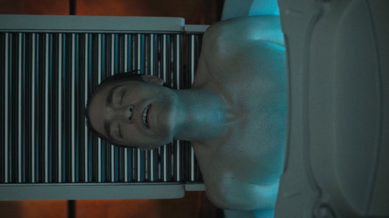 Mickey coming out of a generation machine in "Mickey 17"