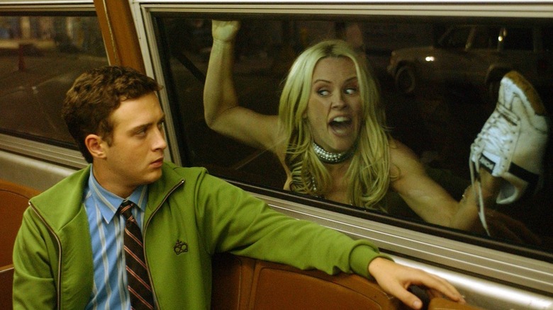 Rebecca stuck to a bus window in "Dirty Love."