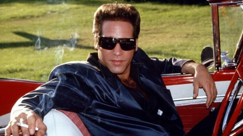 Ford Fairlane sitting in a car in "The Adventures of Ford Fairlane."