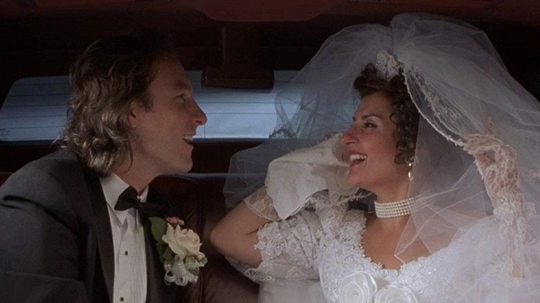 Ian and Toula in the limo after their wedding laughing in My Big Fat Greek Wedding