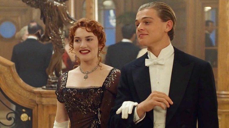 Rose and Jack dressed for a formal dinner at the bottom of the staircase in Titanic
