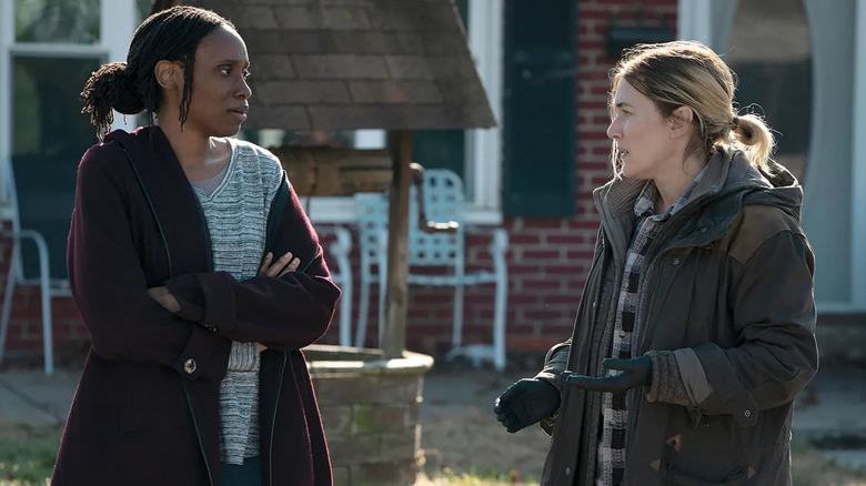 Mare talks to Gayle on the lawn in Mare of Easttown.